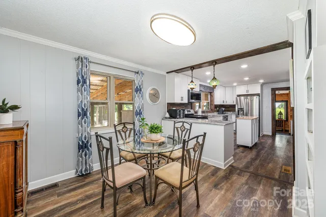 a kitchen with a refrigerator a stove top oven a sink and cabinets