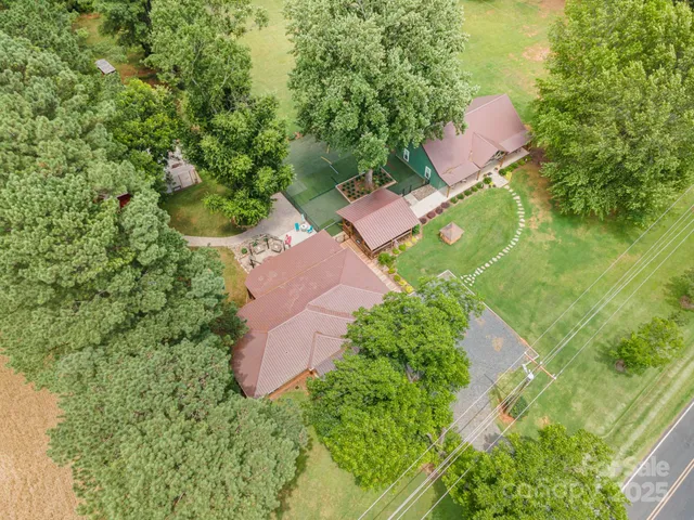 a view of a house with swimming pool and sitting area