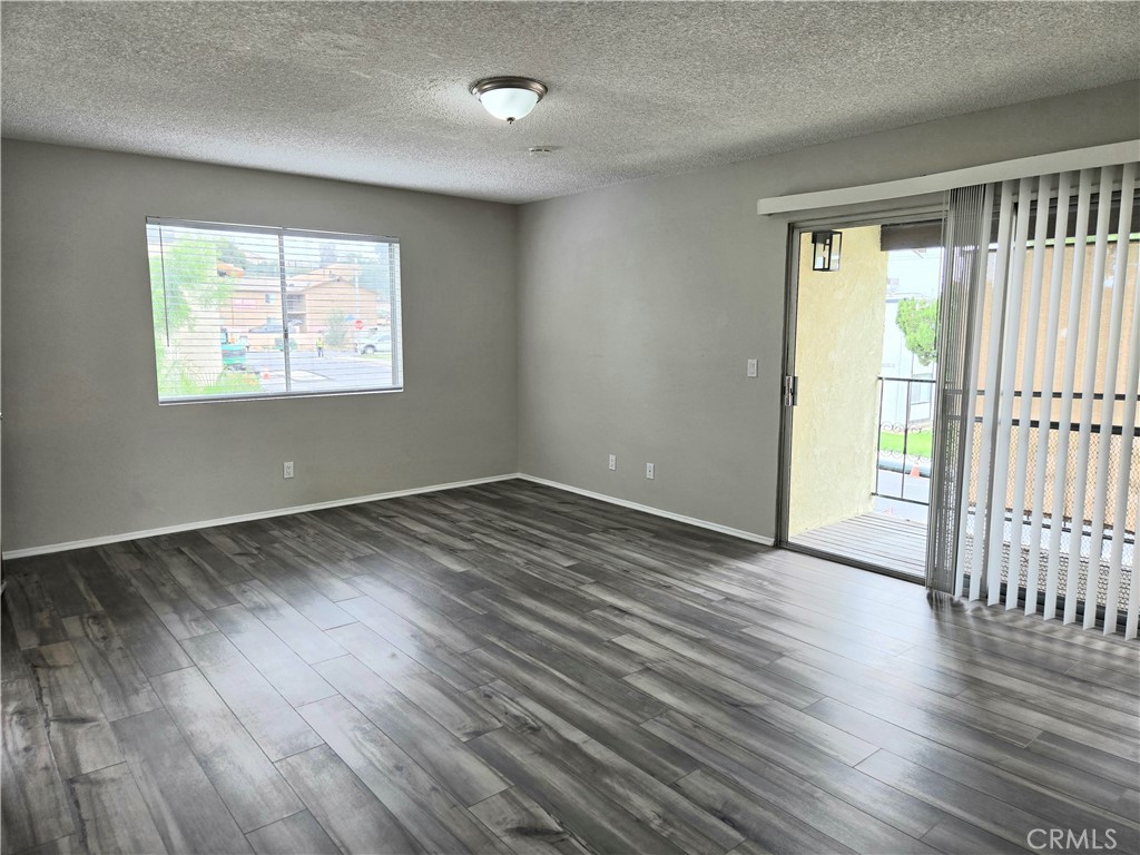 10979 Rincon Street Loma Linda, CA 92354 - Photo 5 of 13 an empty room with wooden floor and windows