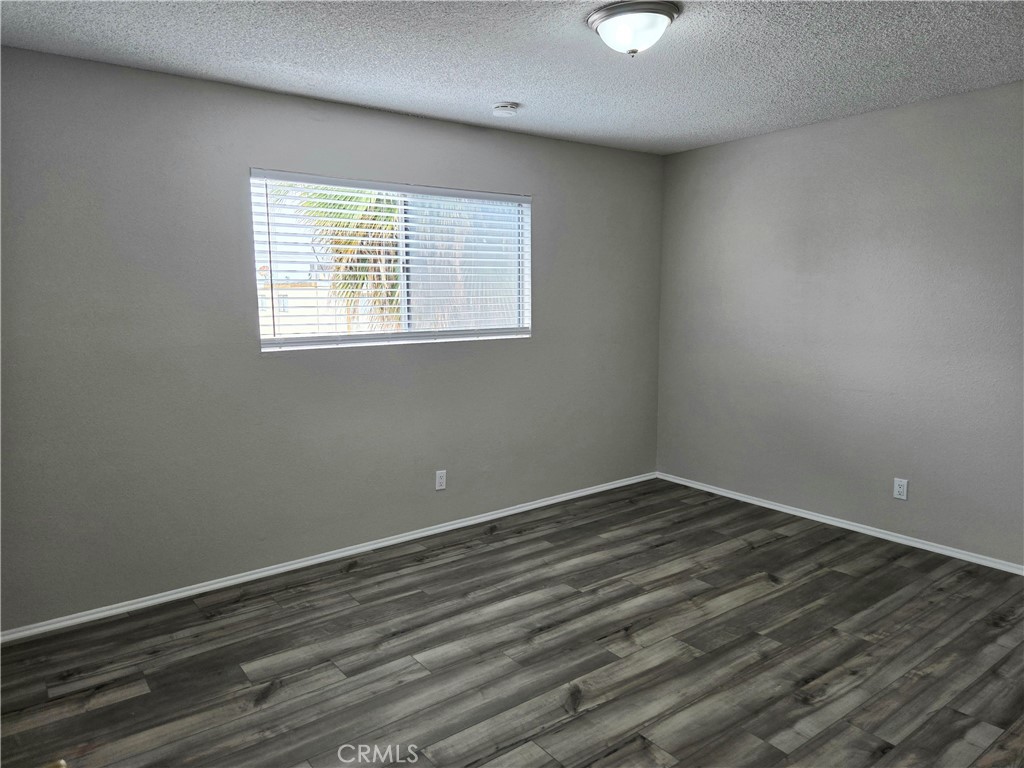 10979 Rincon Street Loma Linda, CA 92354 - Photo 8 of 13 wooden floor in an empty room with a window