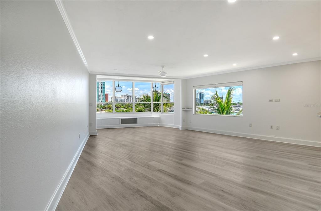 660 Golden Gate Point, Unit 32 Sarasota, FL 34236 - Photo 17 of 52 an empty room with wooden floor and outdoor view
