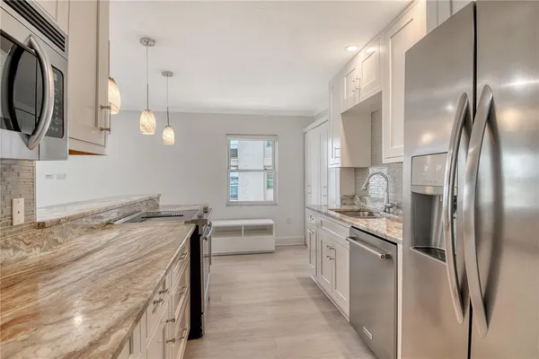a kitchen with a sink stove and cabinets