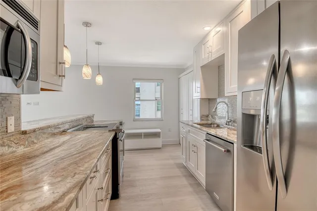 a kitchen with a sink stove and cabinets