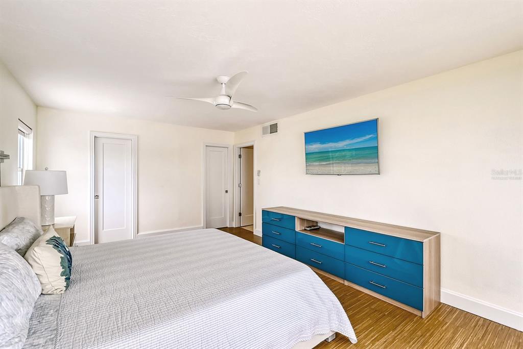 660 Golden Gate Point, Unit 32 Sarasota, FL 34236 - Photo 22 of 52 a bedroom with a bed and a dresser