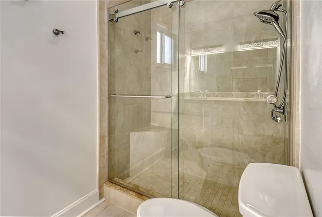 a bedroom with a bed and painting on the wall