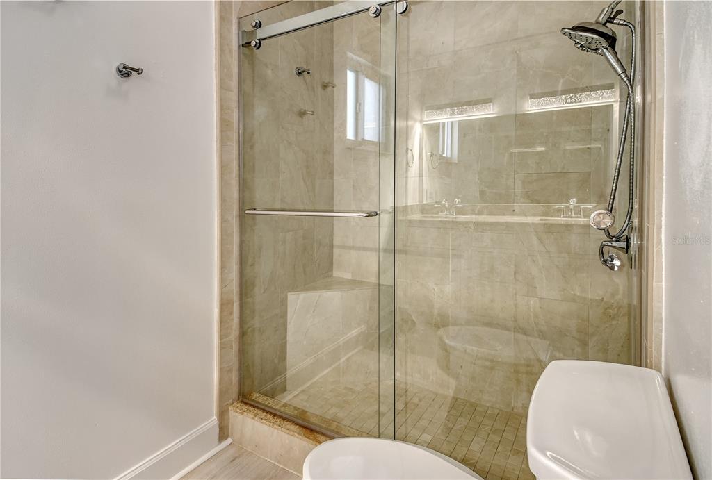 660 Golden Gate Point, Unit 32 Sarasota, FL 34236 - Photo 25 of 52 a bathroom with a shower and toilet