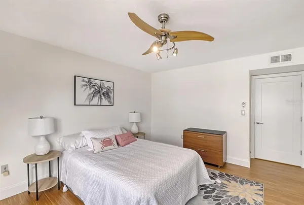 a bedroom with a bed and a chandelier