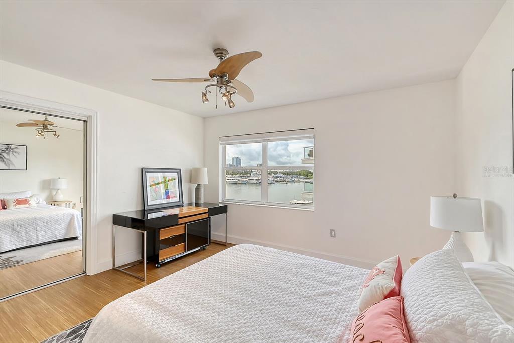 660 Golden Gate Point, Unit 32 Sarasota, FL 34236 - Photo 27 of 52 a bedroom with a bed and a chandelier