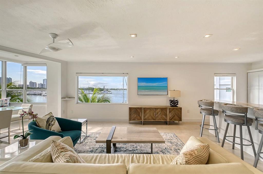 660 Golden Gate Point, Unit 32 Sarasota, FL 34236 - Photo 6 of 52 a living room with furniture and a large window