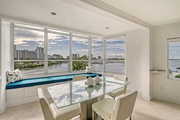 a dining room with furniture a large window and a table