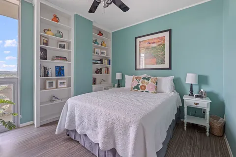 a bedroom with a bed and a book shelf