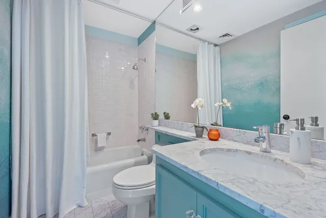 a bathroom with a sink toilet and shower