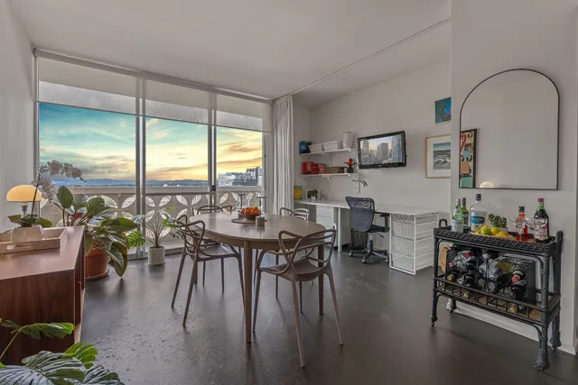 a dining room with furniture window and wooden floor