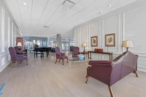 a living room with furniture and a dining table