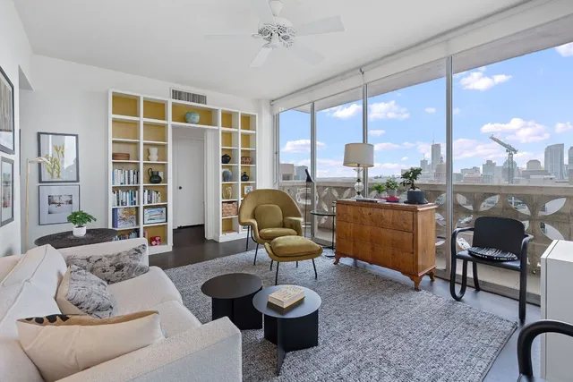a living room with furniture and a large window