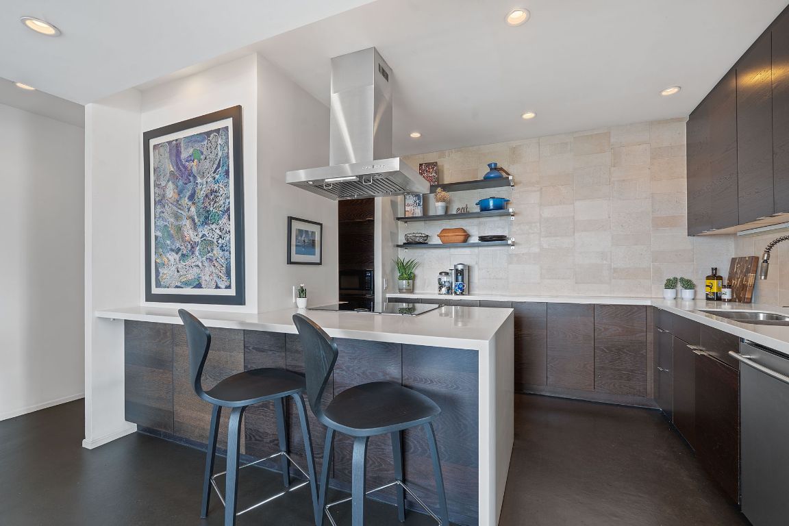 1801 Lavaca Street, Unit 12K Austin, TX 78701 - Photo 8 of 27 a kitchen with stainless steel appliances granite countertop a sink and cabinets