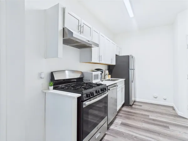 a kitchen with granite countertop a stove and a sink