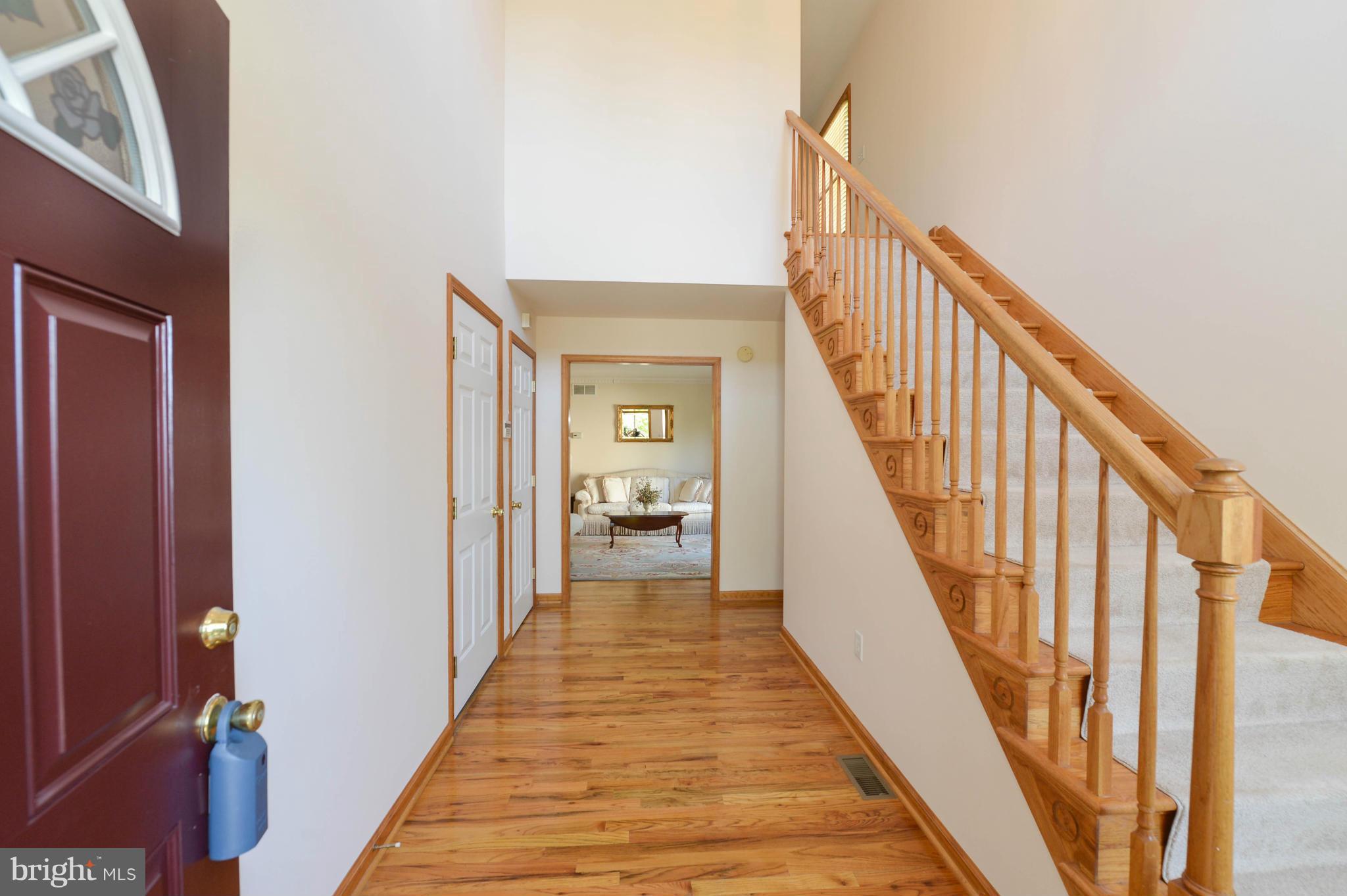 Two Story Foyer- Wood Floors- Leads to Living Room