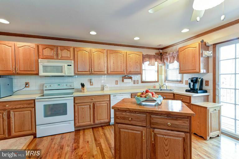 Kitchen opens to Family Room and Sliders to Deck