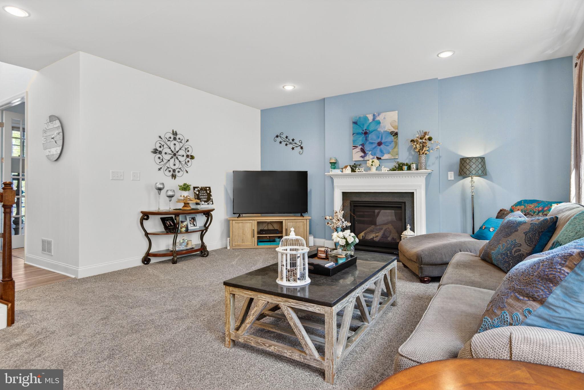 131 Freys Road Elizabethtown, PA 17022 - Photo 31 of 72 a living room with furniture a fireplace and a flat screen tv