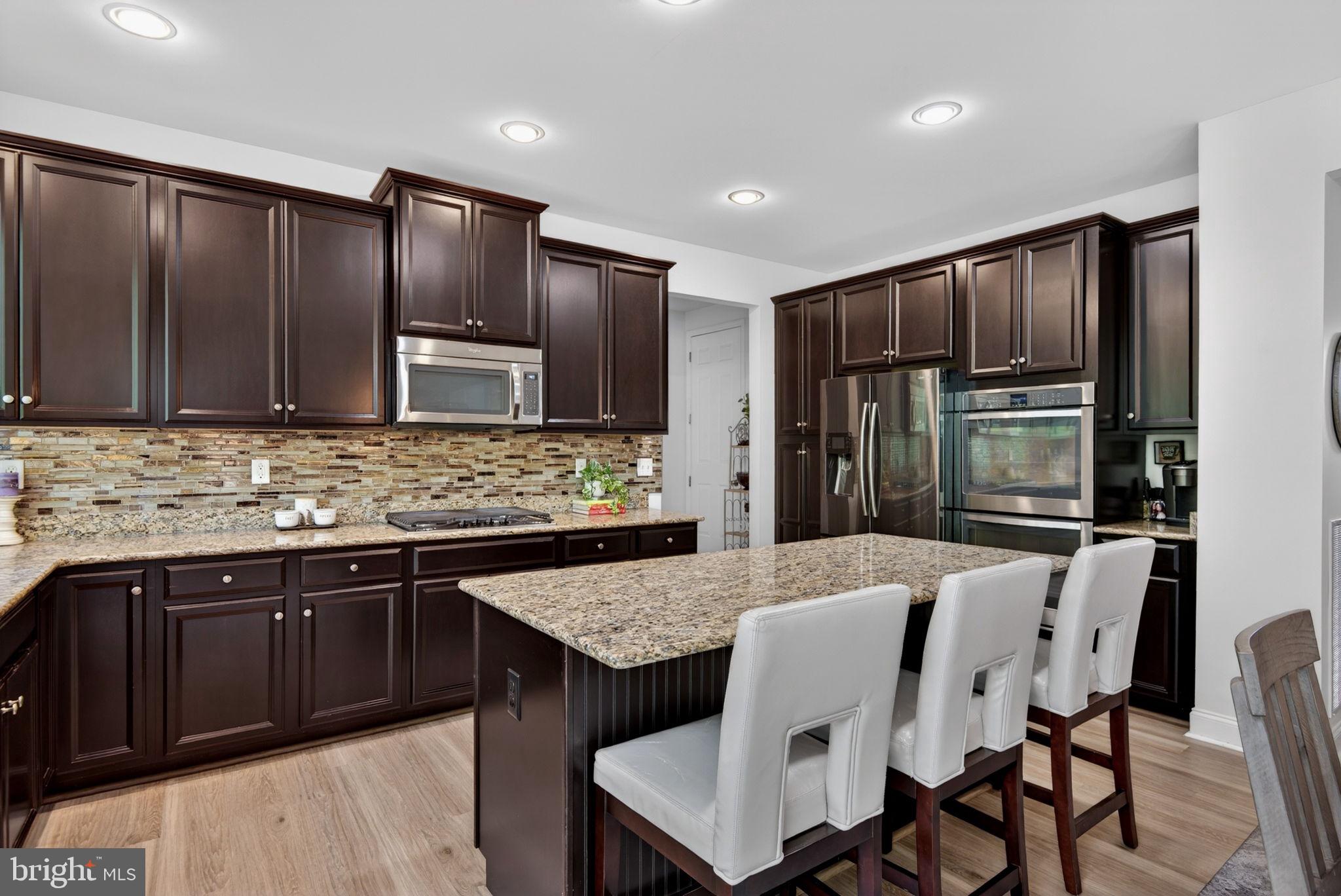 131 Freys Road Elizabethtown, PA 17022 - Photo 40 of 72 a kitchen with kitchen island granite countertop wooden cabinets a refrigerator and a sink