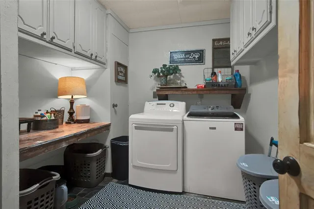 a utility room with sink dryer and washer