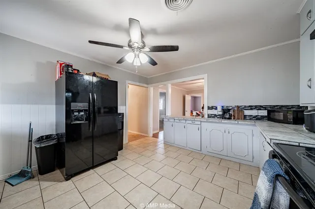 a kitchen with stainless steel appliances granite countertop a refrigerator and a sink