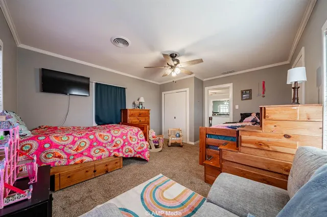 a bedroom with a bed and a chandelier