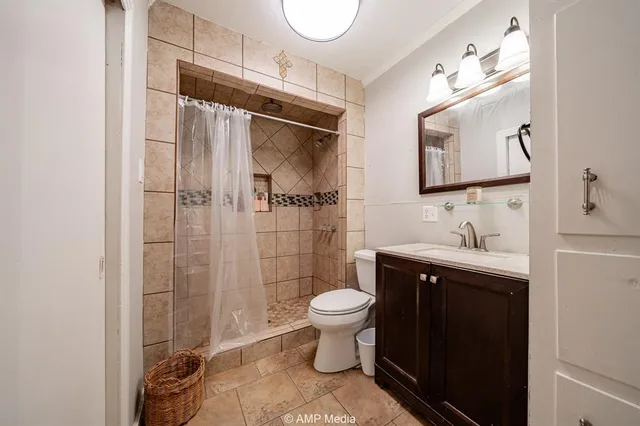 a bathroom with a sink toilet and shower