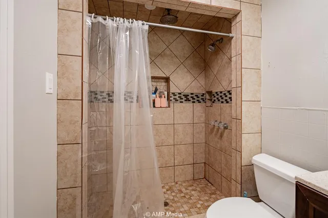 a bathroom with a toilet and shower