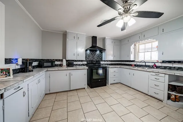 a kitchen with stainless steel appliances granite countertop a sink and cabinets