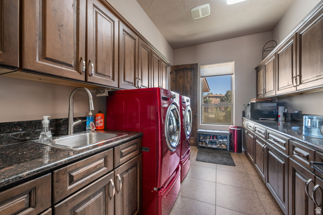 2376 Stone Crest Circle St. George, UT 84790 - Photo 46 of 61 Laundry area featuring washing machine and clothes dryer, dark tile patterned flooring, and cabinet space