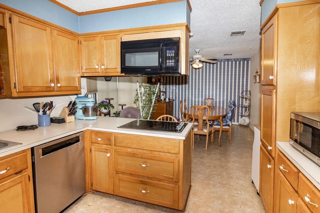 471 Hcr 3335 Road Hubbard, TX 76648 - Photo 14 of 40 a kitchen with stainless steel appliances a stove a sink and a microwave