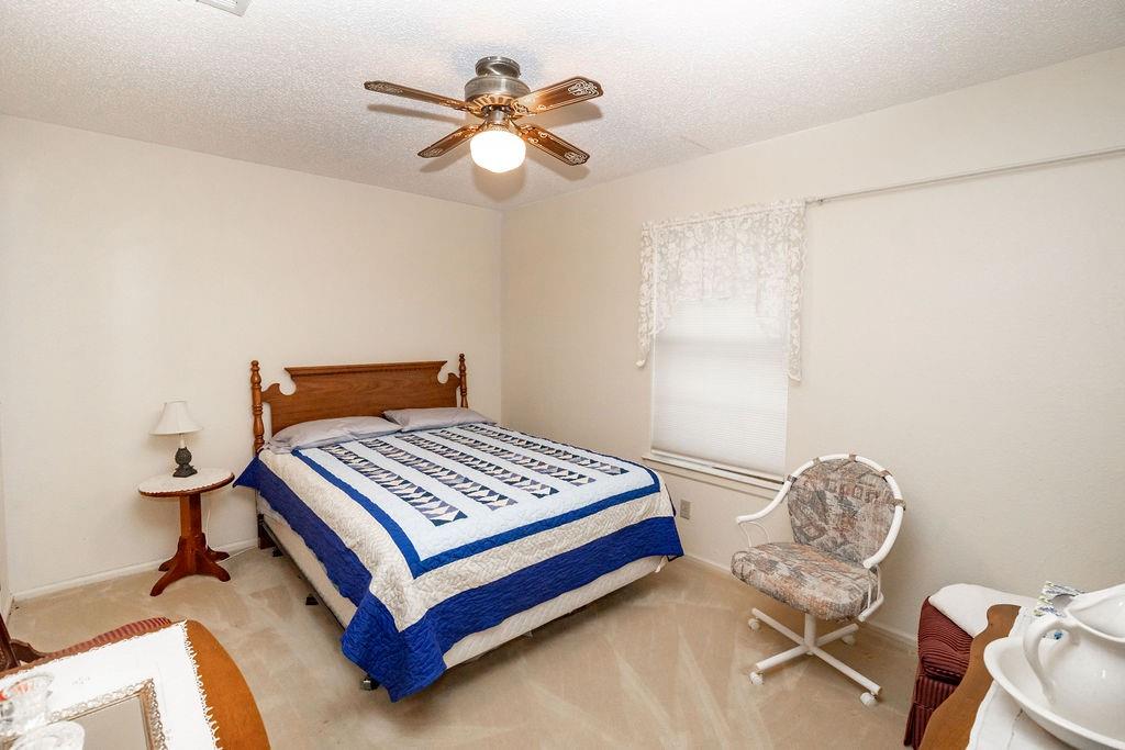 471 Hcr 3335 Road Hubbard, TX 76648 - Photo 18 of 40 a bedroom with a bed and a chandelier