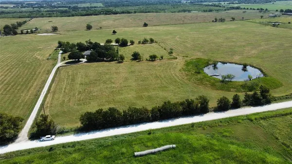 an aerial view of a residential houses with outdoor space