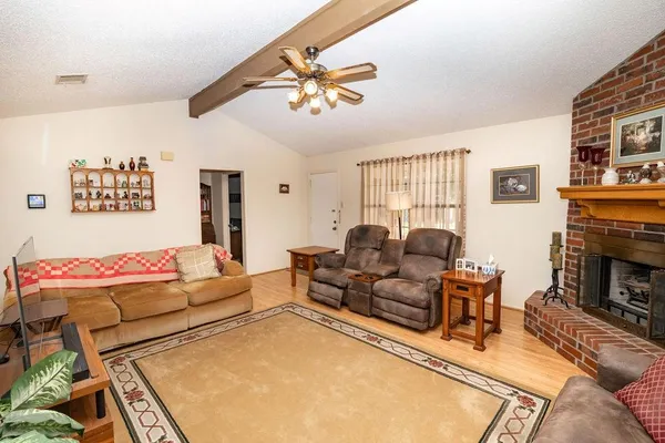 a living room with furniture and a fireplace