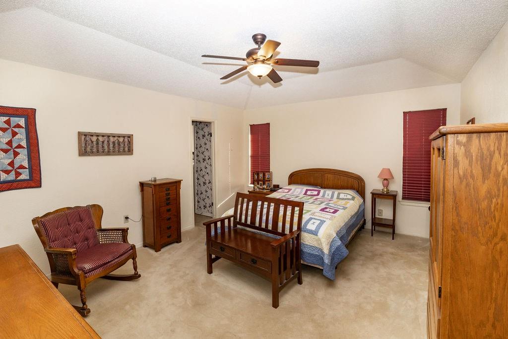 471 Hcr 3335 Road Hubbard, TX 76648 - Photo 7 of 40 a bedroom with a bed and a chandelier