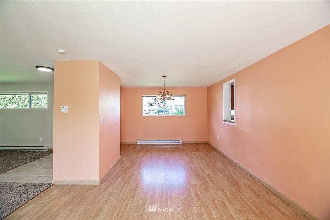1007 Vista Road Ellensburg, WA 98926 - Photo 14 of 26 an empty room with wooden floor chandelier and windows