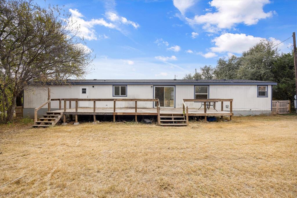2903 Centaurus Way Granbury, TX 76048 - Photo 29 of 31 Back of house featuring a wooden deck and a yard