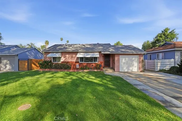 a front view of a house with a garden