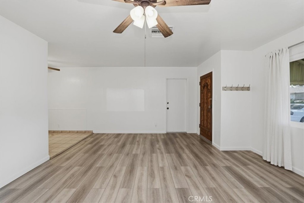 7869 Sycamore Avenue Riverside, CA 92504 - Photo 11 of 36 a view of empty room with wooden floor and fan