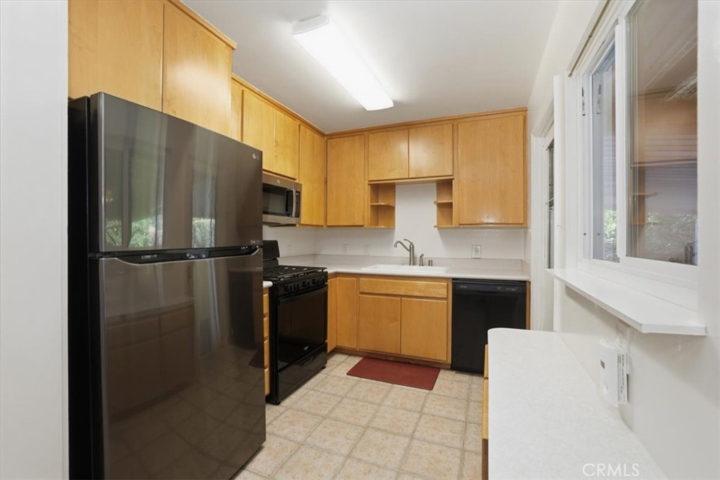 7869 Sycamore Avenue Riverside, CA 92504 - Photo 13 of 36 a kitchen with a refrigerator sink and stove