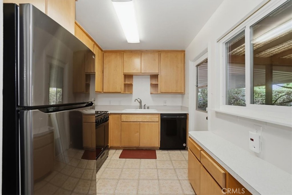 7869 Sycamore Avenue Riverside, CA 92504 - Photo 14 of 36 a kitchen with a sink appliances and cabinets