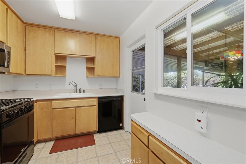 7869 Sycamore Avenue Riverside, CA 92504 - Photo 15 of 36 a kitchen with a sink stove and cabinets