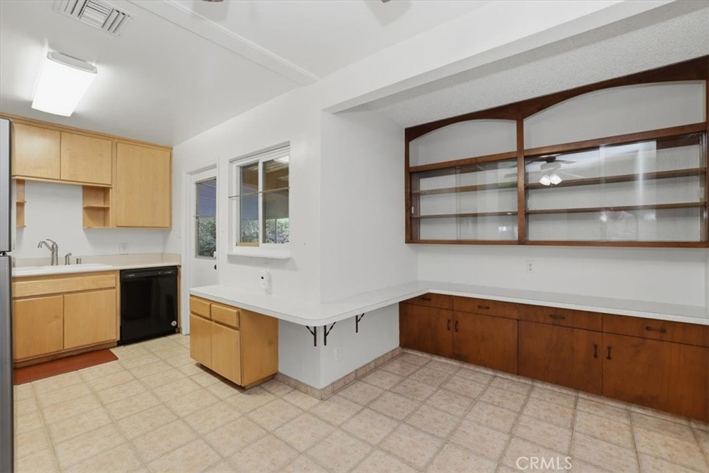 7869 Sycamore Avenue Riverside, CA 92504 - Photo 16 of 36 a kitchen with stainless steel appliances granite countertop a sink and cabinets