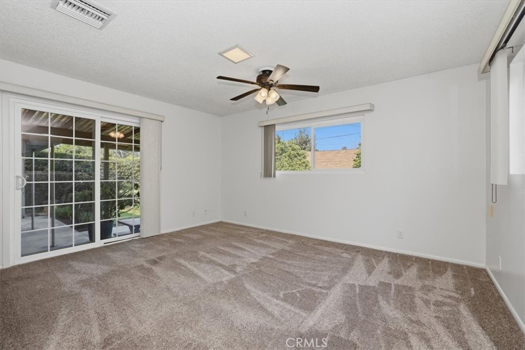 7869 Sycamore Avenue Riverside, CA 92504 - Photo 18 of 36 a view of a big room with windows and ceiling fan
