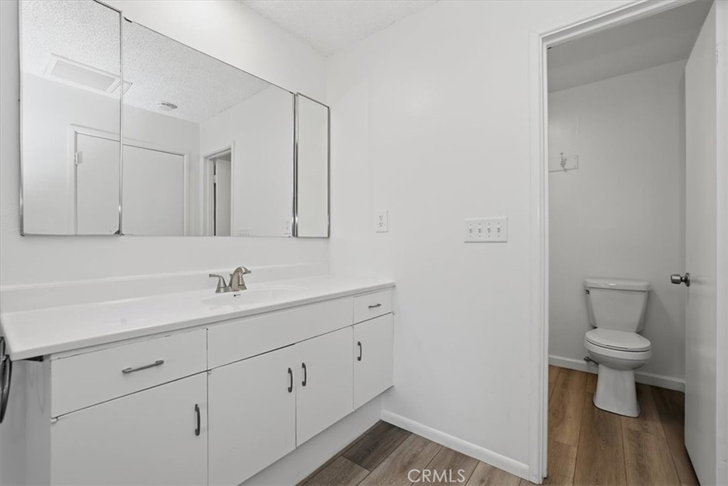 7869 Sycamore Avenue Riverside, CA 92504 - Photo 20 of 36 a bathroom with a toilet a sink and mirror