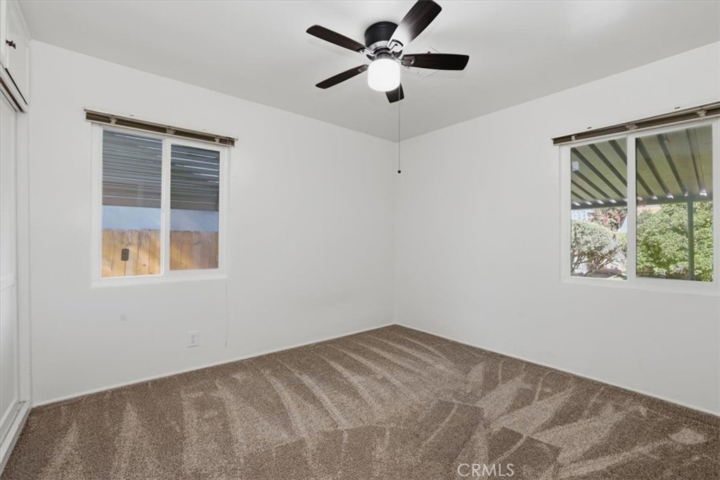 7869 Sycamore Avenue Riverside, CA 92504 - Photo 23 of 36 a view of a big room with windows and chandelier fan