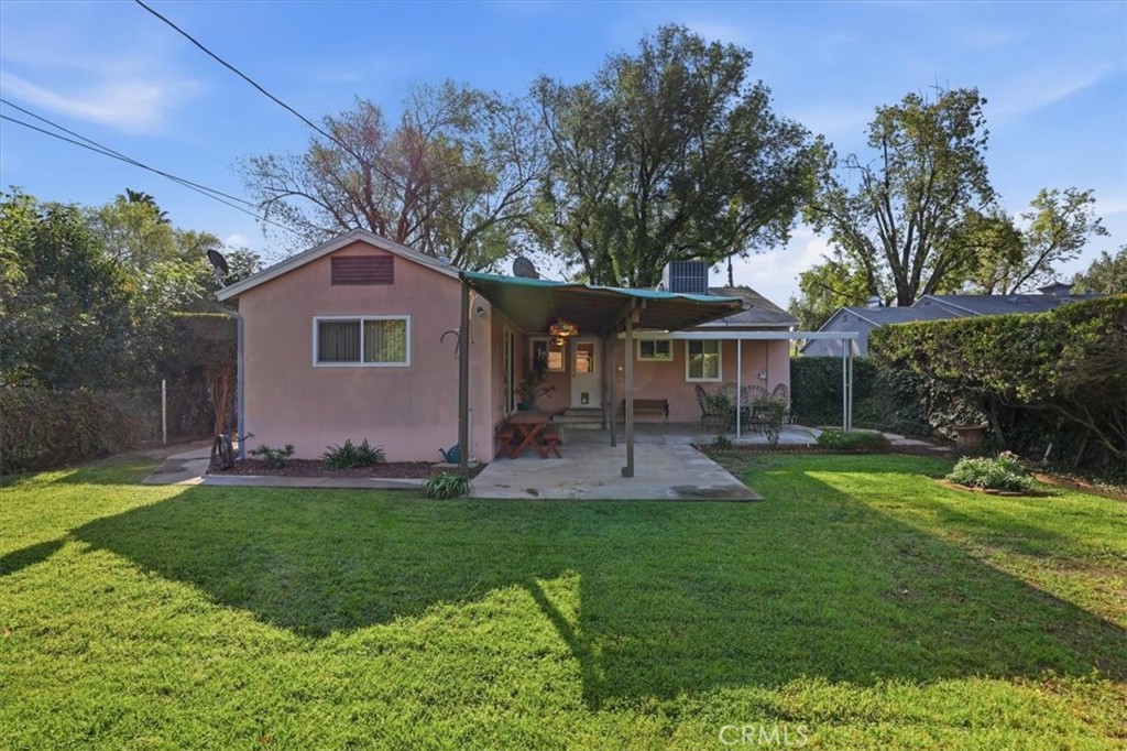 7869 Sycamore Avenue Riverside, CA 92504 - Photo 30 of 36 a front view of a house with a yard and trees