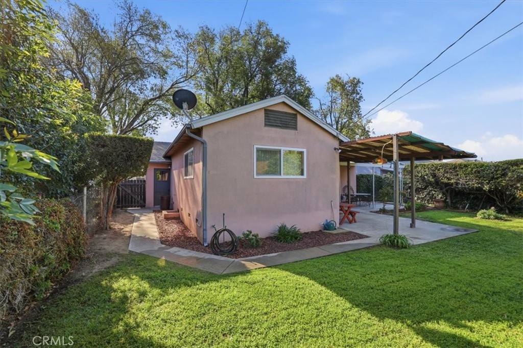 7869 Sycamore Avenue Riverside, CA 92504 - Photo 31 of 36 a view of a backyard with table and chairs potted plants and large tree